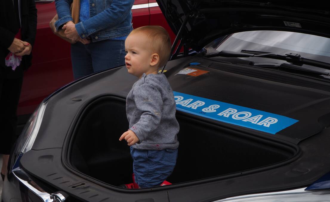 ENOUGH SPACE: A young vehicle enthusiast inspects a Tesla Model S during the opening of Bathurst's permanent Supercharger station yesterday.
