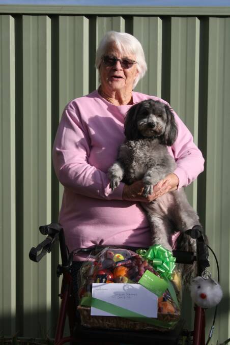KIND GESTURE: Ingenia Gardens Bathurst resident Jenny Evans with her dog, 'Teddy.' Ms Evans donated a food hamper to Forbutt's Pharmacy. Photo: SUPPLIED