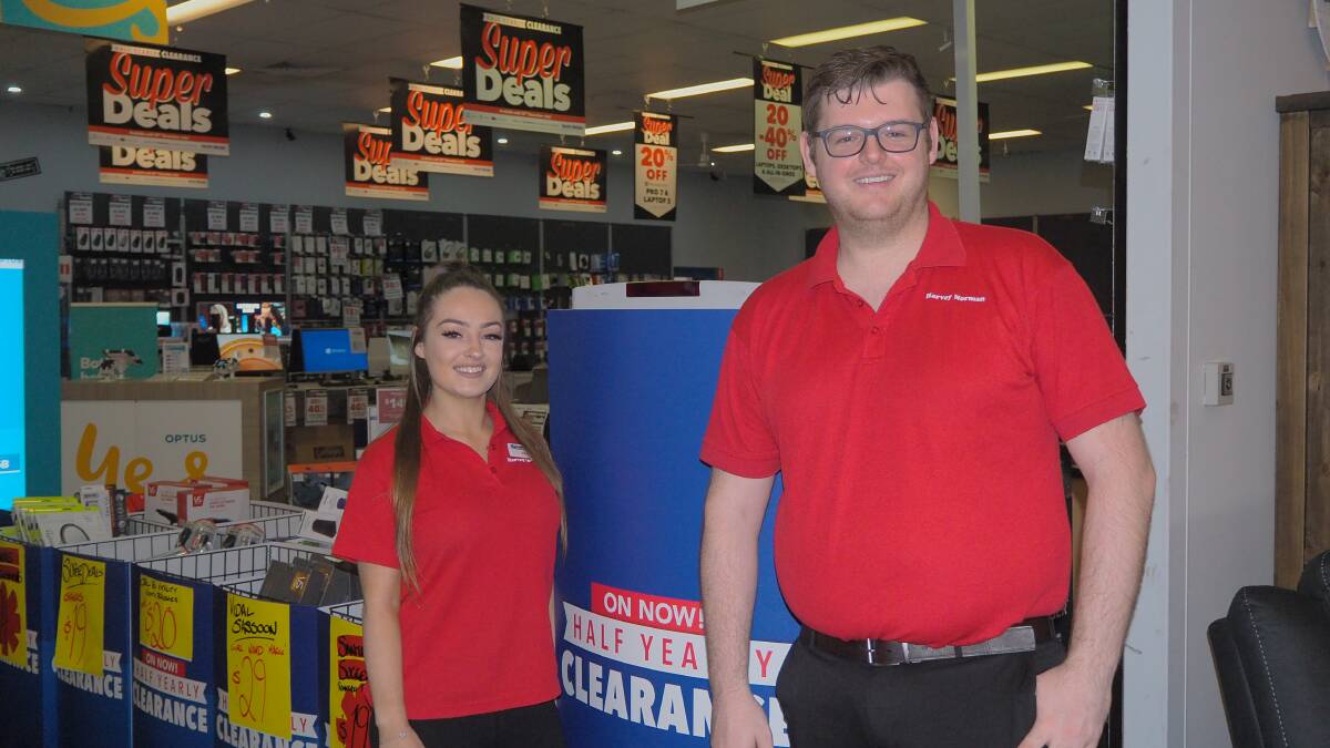 ABUNDANCE OF BARGAINS: Harvey Norman Bathurst's Katie Robins and Ryan Morgan were kept busy with yesterday's Boxing Day sales. Photo: SAM BOLT