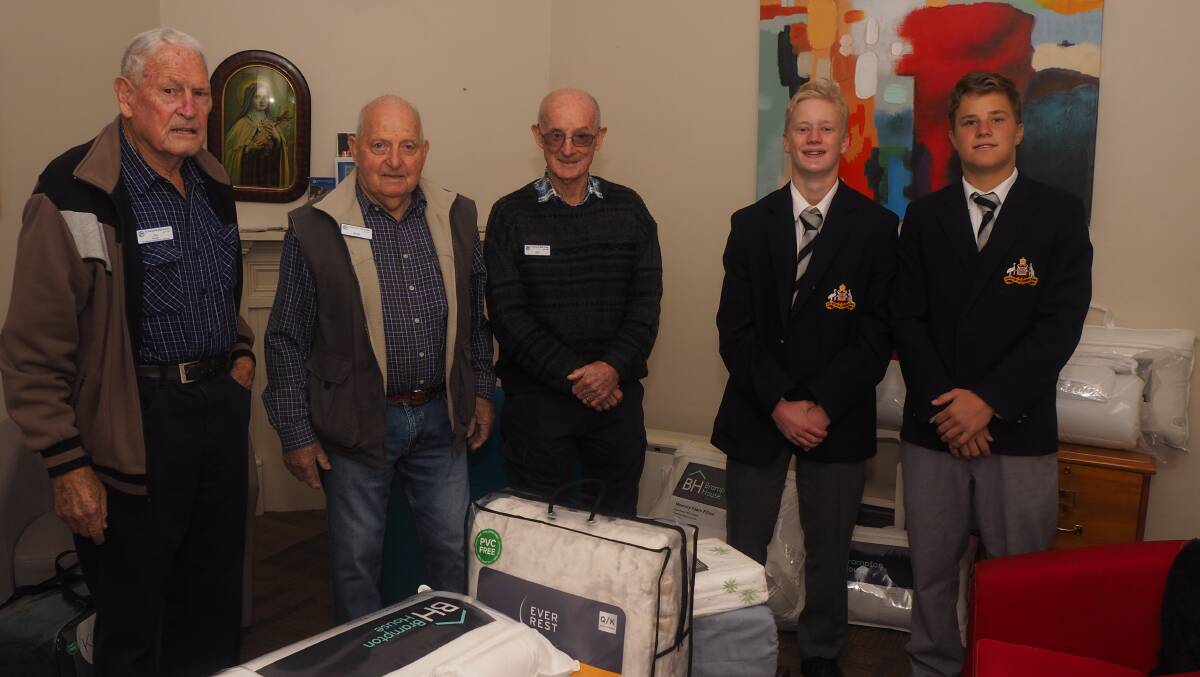 KIND GESTURE: St Vincent de Paul Society members Joe Casey, Mark Seaman and Reg Stapleton with St Stanislaus' College Year 10 students Joe Anderson and Rory Suillivan. Photo: SAM BOLT