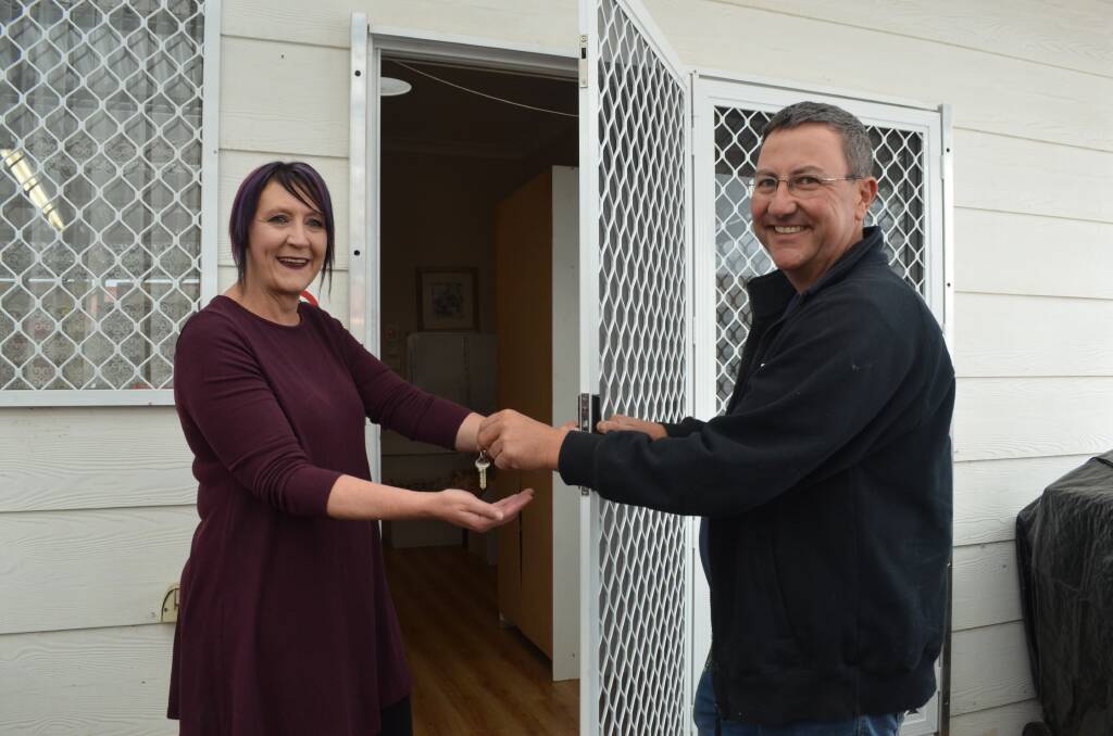 FOR YOU: Pay It Forward's founder Karlie Irwin takes the keys to the door donated by RCG Security Doors' Rodney Graham. Photo: DECLAN RURENGA 1006drpif1
