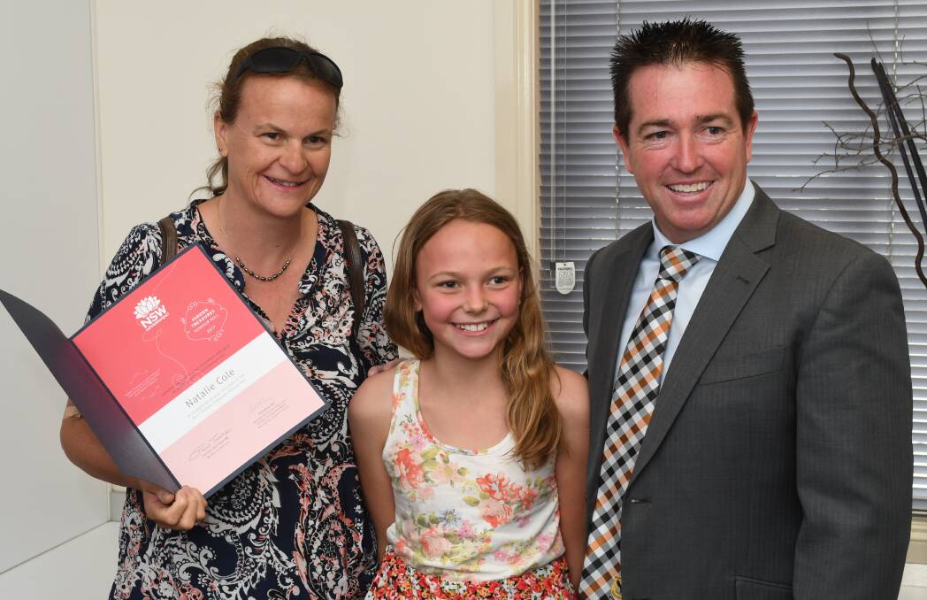DEDICATED: Natalie Cole with her daughter, Amelia, 10, receiving her Hidden Treasures Honour Roll certificate from Bathurst MP Paul Toole. Photo: CHRIS SEABROOK 010918cawards1