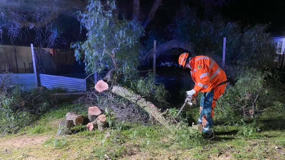 CLOSED: Bathurst's SES crews removing a large tree branch that fell down partially blocking a road in Raglan. Photo: BATHURST SES