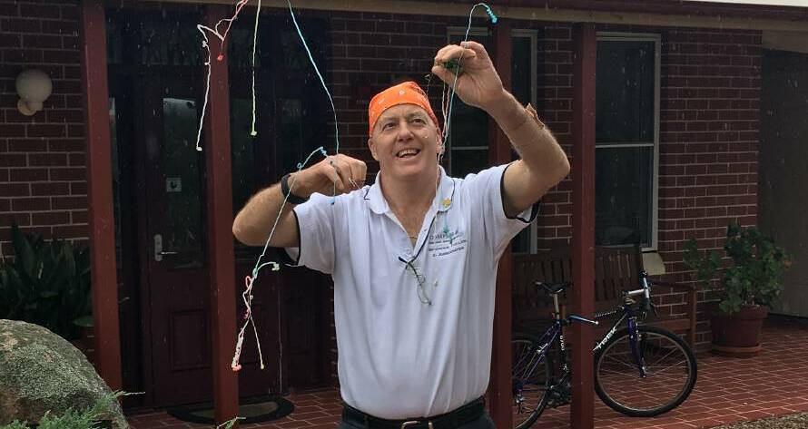  TIME TO GET LIVING: David Fuller pops a party popper to celebrate the completion of his treatment for prostate cancer in 2017. Photo: SUPPLIED 081418fuller
