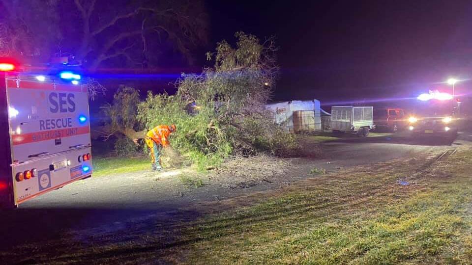 CLOSED: Bathurst's SES crews removing a large tree branch that fell down partially blocking a road in Raglan. Photos: BATHURST SES