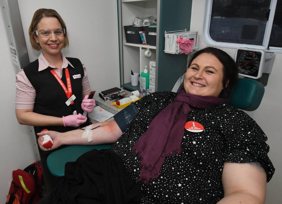SAVING LIVES: Australian Red Cross Blood Service registered nurse Liesa Pansini with first-time donor Katreena Shelly. Photo: CHRIS SEABROOK