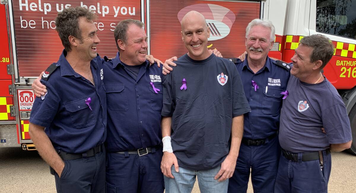 SUPPORT: Firefighters Paul Dunn, Tim Anderson, Station Officer Chris 'Colonel' Sanders and firefighter Mark Birdsville have been there to support (centre) Anthony Baillie during his treatment. Photo: NADINE MORTON 040419cleo