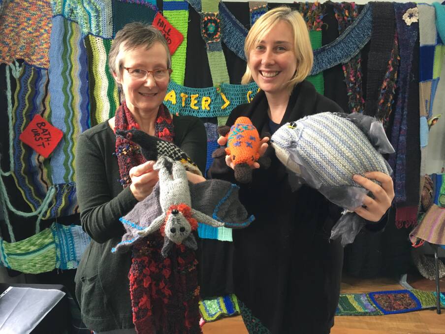 LOOK AROUND: Wendy Alexander and Anastasia Freeman, from River Yarners, with some of the knitted animals. Photo: NADINE MORTON041218nmknit1