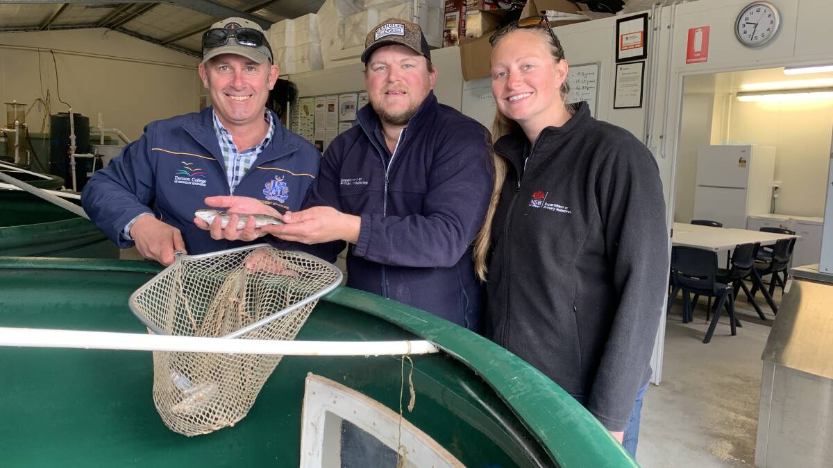 SPECIAL CARGO: Bathurst High technological and applied studies head teacher Patrick Ford with Gaden Trout Hatchery's Mitch and Taylor Elkins are working together to rejuvenate NSW's brook trout stocks. Photo: SUPPLIED