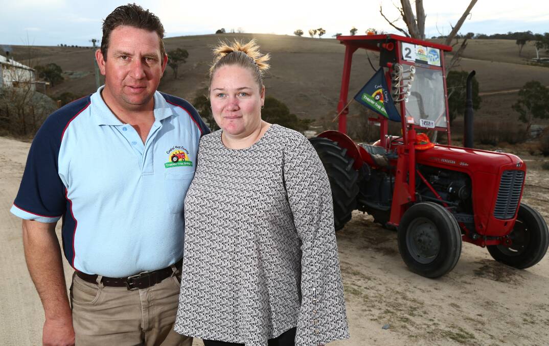 MOTORS RUNNING: Nick and Amy Clancey with their 1962 Massey Ferguson tractor that will lead the inaugural charity 24 Hour Tractorthon. Photo: PHIL BLATCH 062718pbtractor2