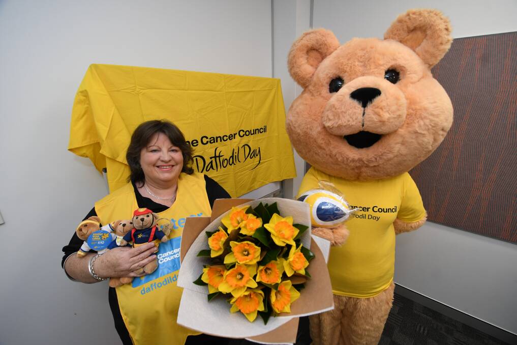 LENDING THEIR SUPPORT: Debbie Lynch-Benham with her daughter Larissa, dressed as Dougal Bear, promoting Daffodil Day. Photo: CHRIS SEABROOK 082018cdafodls1