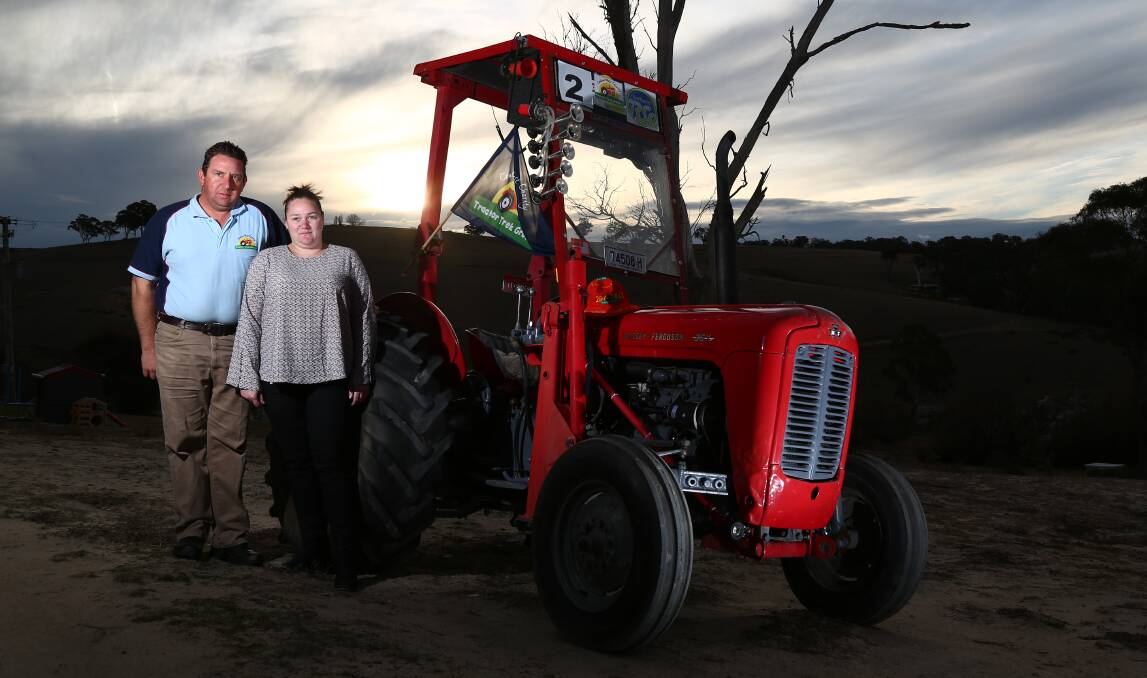 MOTORS RUNNING: Nick and Amy Clancey with their 1962 Massey Ferguson tractor that will lead the inaugural charity 24 Hour Tractorthon. Photo: PHIL BLATCH 062718pbtractor1
