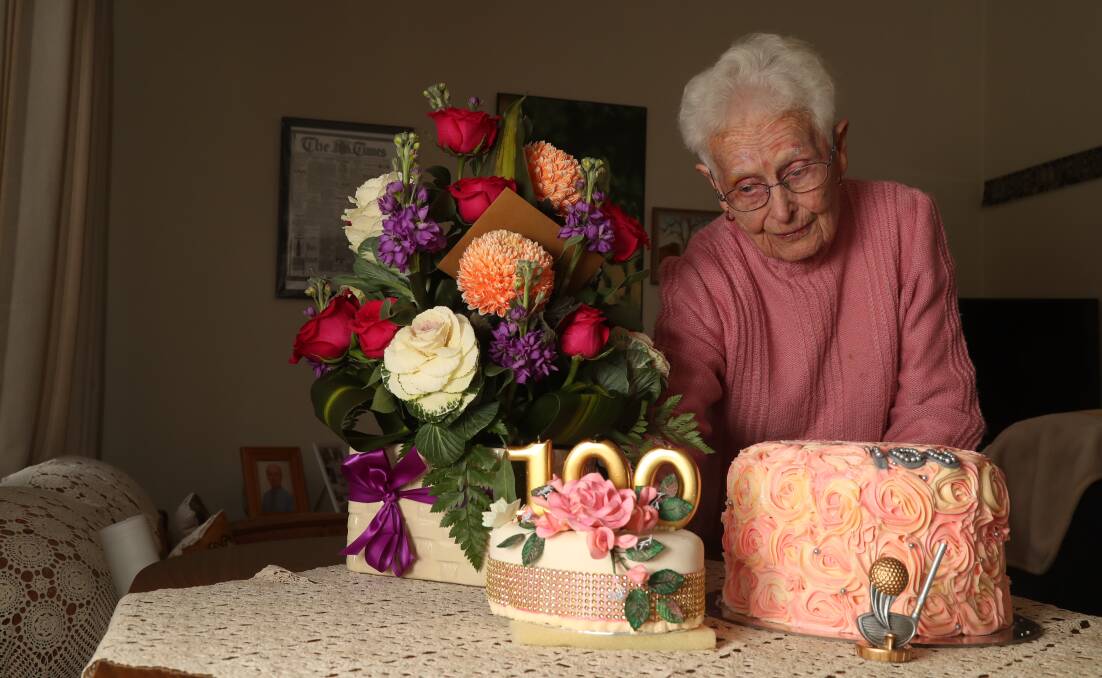 WHAT A WOMAN: Francie Morris with one of her four birthday cakes and numerous bunches of flowers that she received. Photo: PHIL BLATCH 071017pbfrancie5
