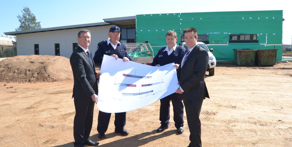 NEW CENTRE: Bathurst mayor Gary Rush, NSW Rural Fire Service's Jeff Larsen and Mick Holland, and Member for Bathurst Paul Toole with plans for the new fire control centre being built. Photo: NADINE MORTON 090516nmfire4