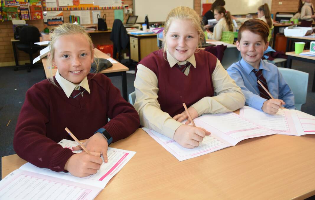 TEST READY: Holy Family Primary School Year 5 students Maddi Honeyman, 10, Chloe Bennetts, 11, and Sebastian Prior, 10, say NAPLAN is nothing to be nervous about. Photo: NADINE MORTON 051618nmnaplan