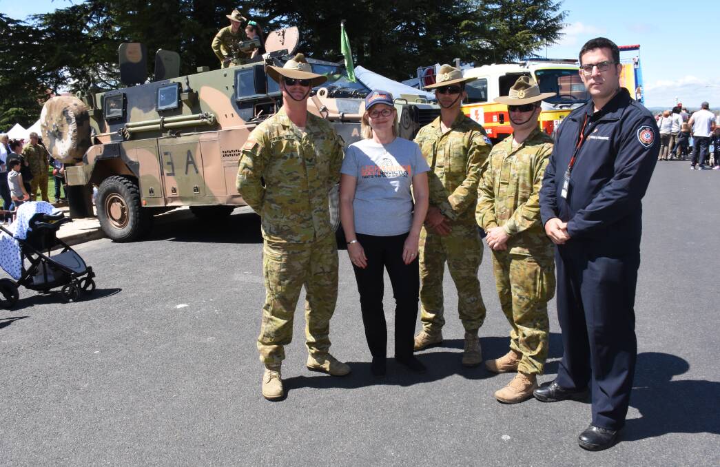 STANDING TALL: Fabian Scholte, Convoy spokeswoman Sally Hodder, Mat Smith, Ricky Gillon and Queensland Fire and Emergency Services firefighter Kalam Waller during their visit to the Bathurst 1000 Saturday Street Fair. Photo: NADINE MORTON 100618nmptsd