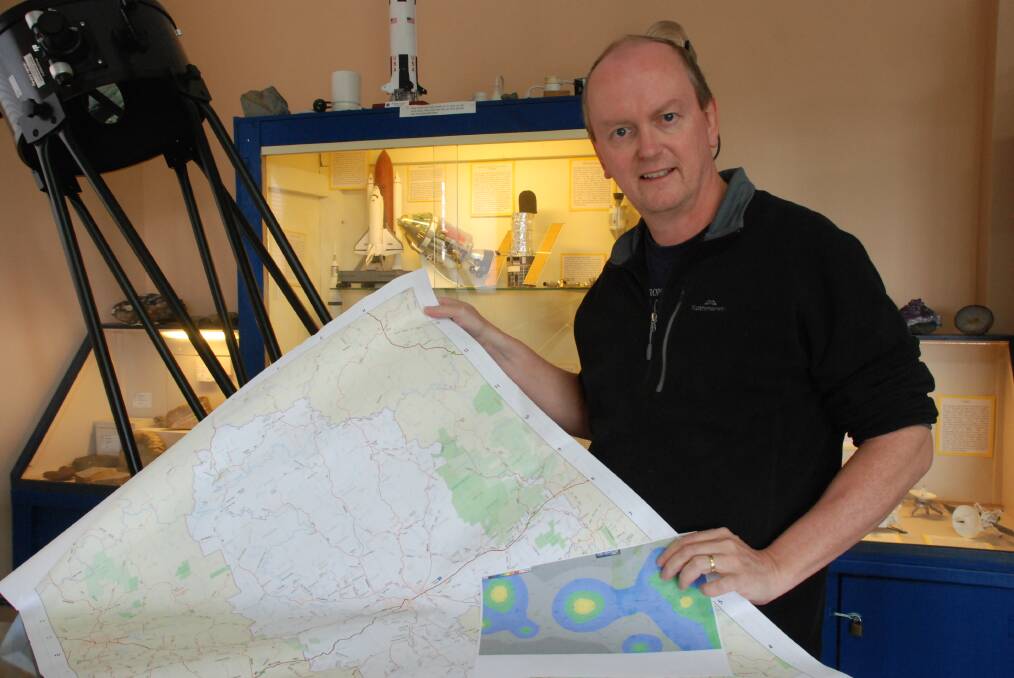 TIME TO MOVE: Bathurst Observatory's Ray Pickard holding a map of Bathurst and also a map showing light pollution around the region which is impacting the observatory. Photo: SUPPLIED 041117ray2