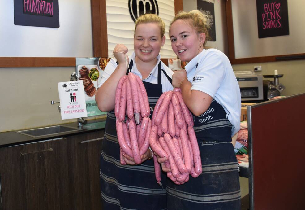 GOOD CAUSE: Mountain Meats' Hannah Smith and Karlie McPhillamy with the McGrath Foundation sausages. Photo: NADINE MORTON 010518nmsnags
