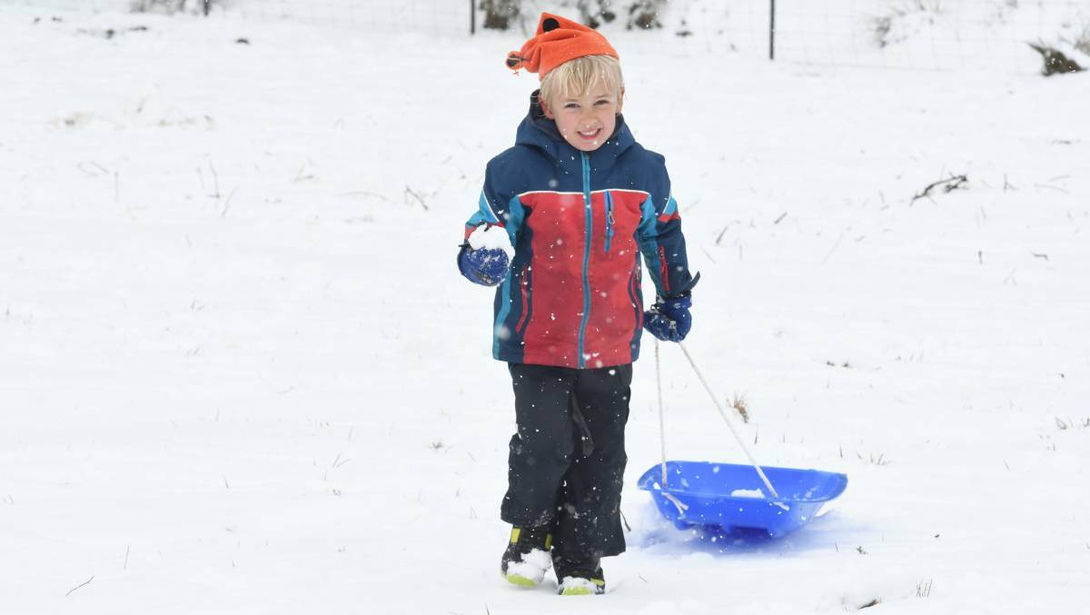 ALL SMILES: Leon Smedley was among thousands of residents who enjoyed the snow when it fell across the region earlier this month. Photo: JUDE KEOGH