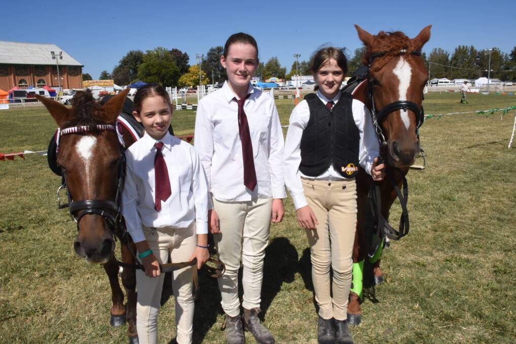 SHOW FUN: Bathurst Pony Club members Hannah Jonker, 11, Makaylah Shirvill, 13, and Courtney Roberts, 13, with horses Sugar and Jamilla during Thursday's competition. Photo: NADINE MORTON 041218nmshow2