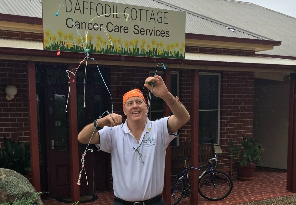 TIME TO GET LIVING: David Fuller pops a party popper to celebrate the completion of his treatment for prostate cancer in 2017. Photo: SUPPLIED 081418fuller