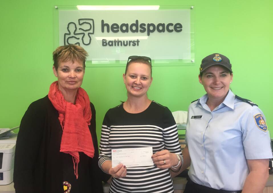 HELPING HANDS: headspace Bathurst's Nicki Halliwell receives a $1000 donations from Kirkconnell Correctional Centre staff members Susie McLean and Penny Wellings. Photo: SUPPLIED 110717kirkconnell