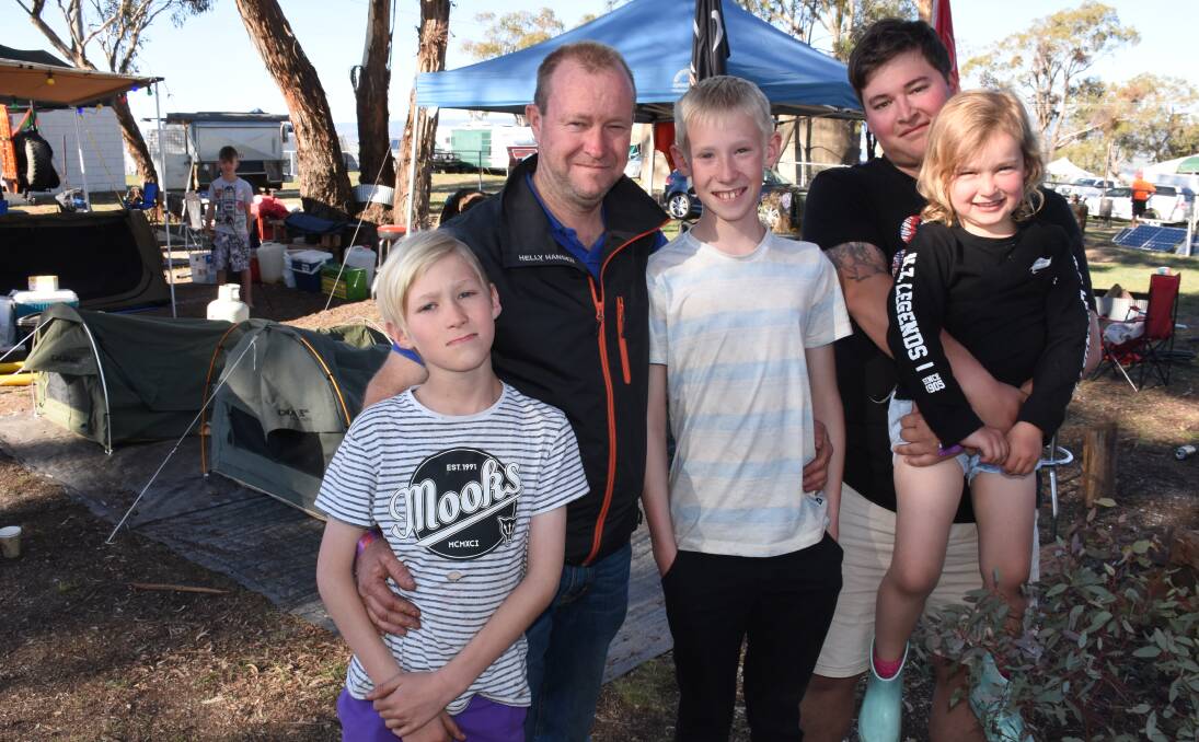FAMILY FUN: Nathan Healy with his three sons Cameron, 10, and Jamie Healy, 13, Payton Bradcock and granddaughter Kelsey Bradcock, 4, are camping on Mount Panorama for the Bathurst 1000. Photo: NADINE MORTON 100218nmfans7