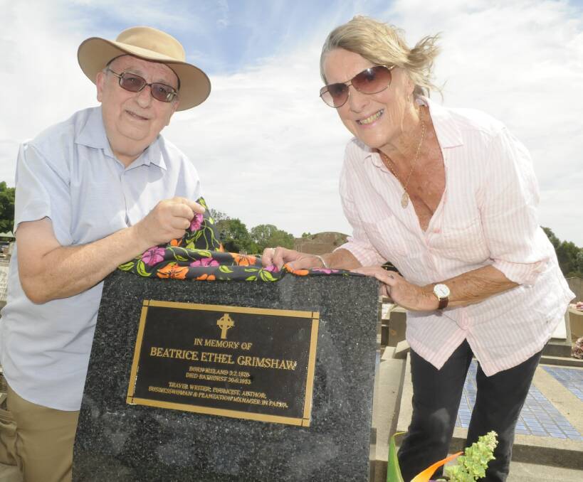 RECOGNITION: Bathurst Family History Group secretary Graeme Hill and Irish travel writer Diana Gleadhill unveil the headstone and plaque for Beatrice Grimshaw at Bathurst Cemetery. Photo: CHRIS SEABROOK 011117cgrave1