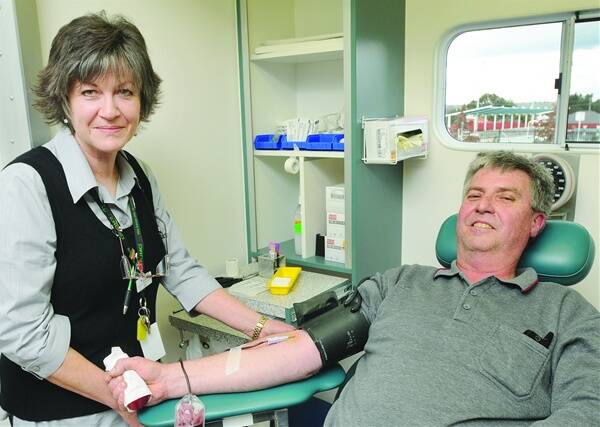 DONATE BLOOD: Registered nurse Kez McCarthy taking blood from regular blood donor Greg Howard who has been giving blood for 29 years.