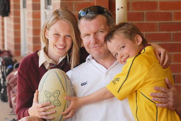 GO SCOTLAND: James McLaren, who was part of the 2003 World Cup rugby side, now lives in Bathurst. He is pictured with his daughter Phoebe and son Brodie. PHOTO ZENIO LAPKA 091511zcup
