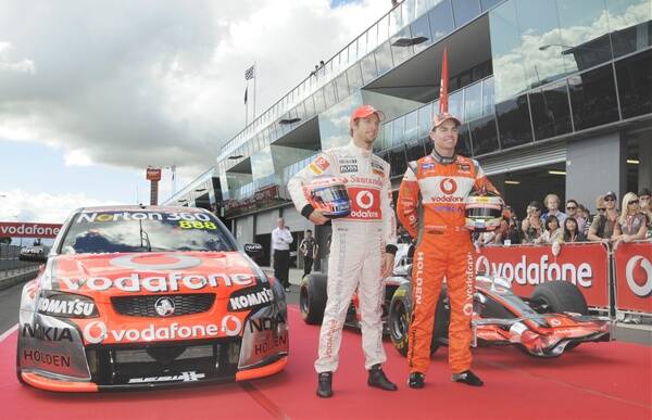 MAN AND MACHINE: Jenson Button (left) and Craig Lowndes with the Mercedes McLaren and Holden Commodore they drove at Mount Panorama. Photo: CHRIS SEABROOK 032211cvoda5d
