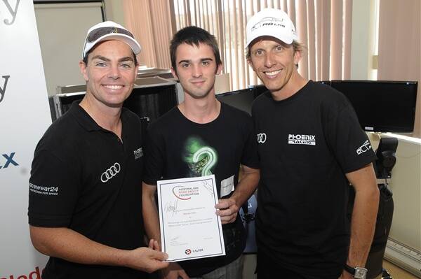 ONCE IN A LIFETIME: Audi R8 LMS drivers Craig Lowndes and Warren Luff present Bathurst schoolboy Michael Coles with his Australian Road Safety Foundation certificate at yesterday’s driving training session. Photo: PHILL MURRAY 022412pcraig1