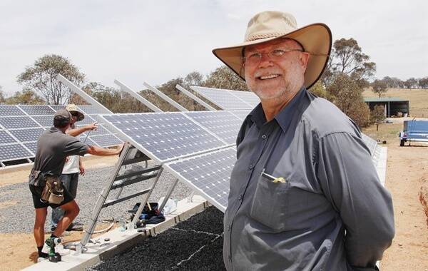 SUNNY FUTURE: Dr Larry Fingleton watches his new solar farm take shape. Photo: ZENIO LAPKA 122409zsolar1