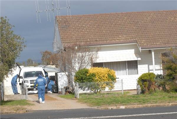 CRIME SCENE: A weatherboard cottage in a quiet back street in Cowra was still being examined by forensic investigators yesterday, 24 hours after two children and a grandmother were killed and an off-duty policewoman badly hurt in a savage axe attack. Photo: Phill Murray 070108pcowra3