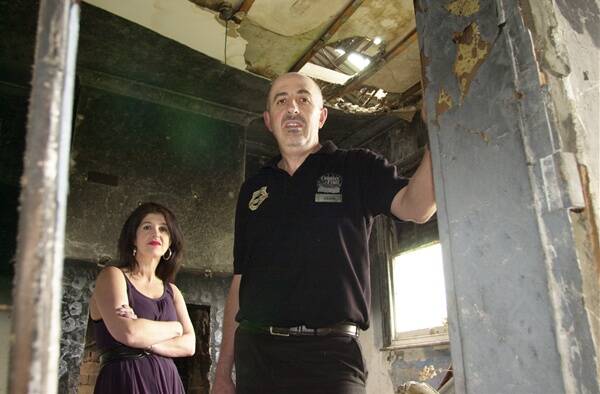 BEYOND REPAIR: Craig and Dianne Sharah inside one of the cottages at 133-137 Keppel Street.