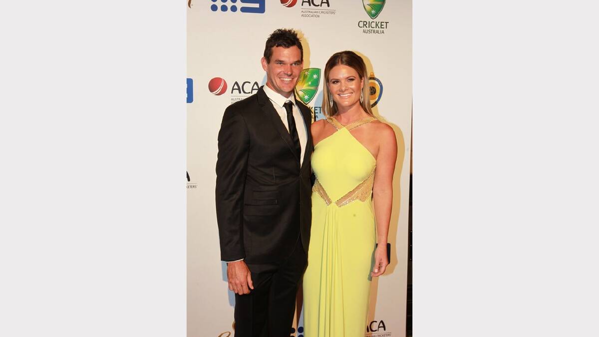  Clint McKay and Kirsten Tuzee arrive at the 2014 Allan Border Medal on Monday night. Picture: Ben Rushton 