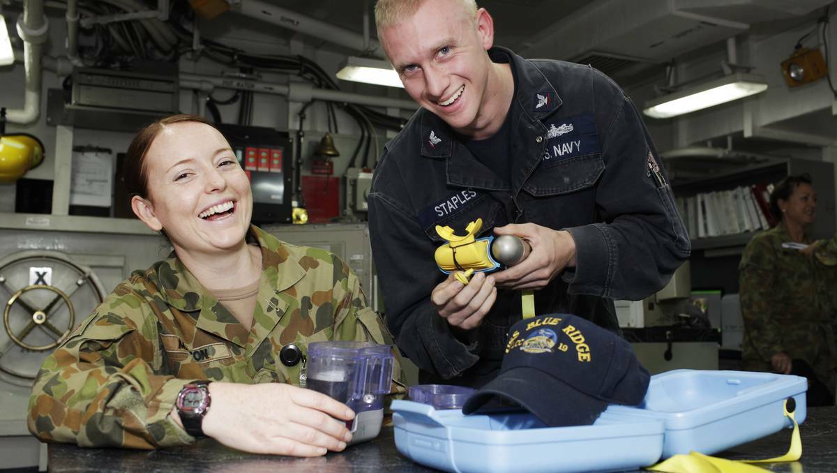 DUBBO: Lieutenant Jasmin Martin gets a demonstration on how to use breathing apparatus from hull technician Michael Staples of USS Blue Ridge.