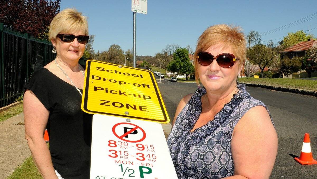 NEW ZONE: Bathurst High School relieving principal Jenny Stirling and Tablelands road safety officer Iris Dorsett with one of the new signs. 