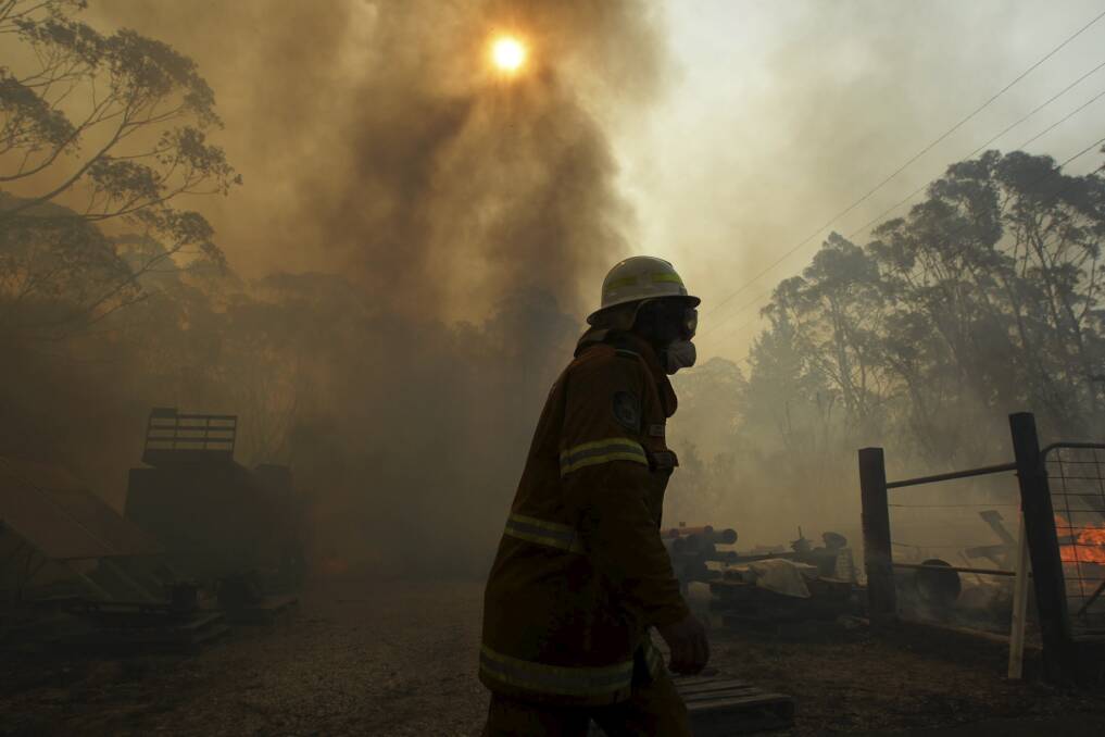 CLARENCE: RFS firefighters battle to protect properties. Photo: Dean Sewell.