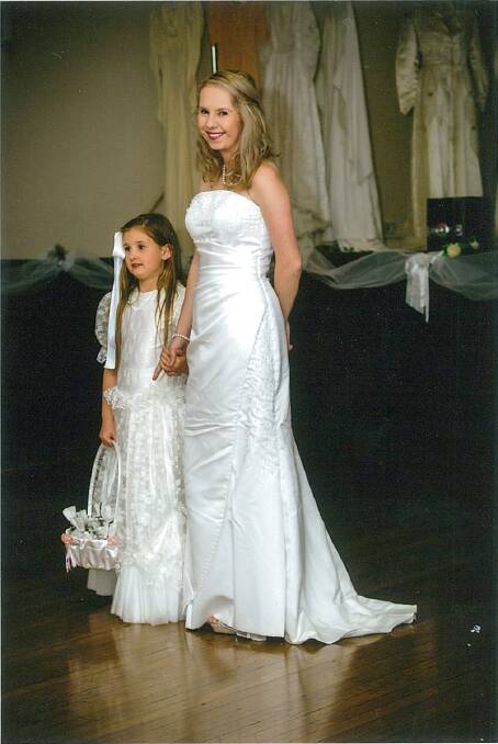 2003: White satin strapless dress embroidered with crystals across the top. The back of the dress had crystal buttons and a small fishtail type train. This dress was worn by Deanne Wade when she married Gary on March 1, 2003 at Perthville Uniting Church. Worn at the show by Ashleigh Fulton.