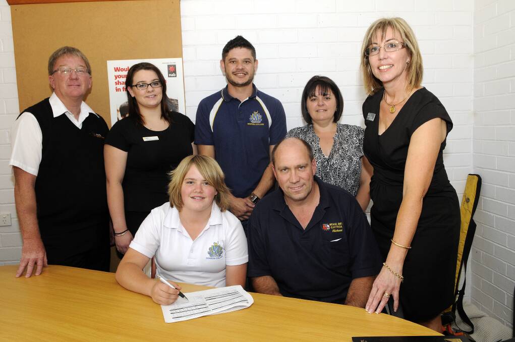 GETTING A TRADE: TAFE Western's Alden McCann, Krystal-Ann Radford, Des Crawford, Karren Smith and Carolyn Murphy and (seated) Bathurst High School student Emily Smith and Michael Smith during the sign-up. Photo: Phil Murray 112113papprent