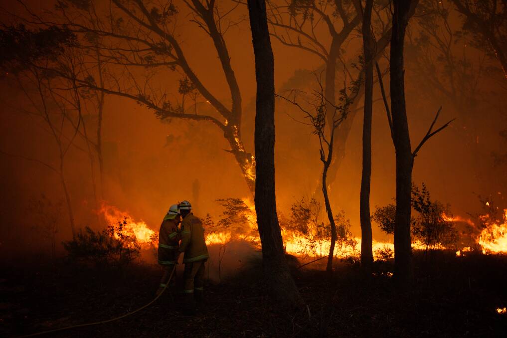 WARZONE: NSW RFS crews struggle to save a home near Dargan on the Bells Line of Road, October 17. Photo: Wolter Peeters 