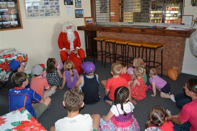 SNAPPED: Santa recently visited the Bathurst Aero Club Christmas party. Santa enthralls an eager crowd.