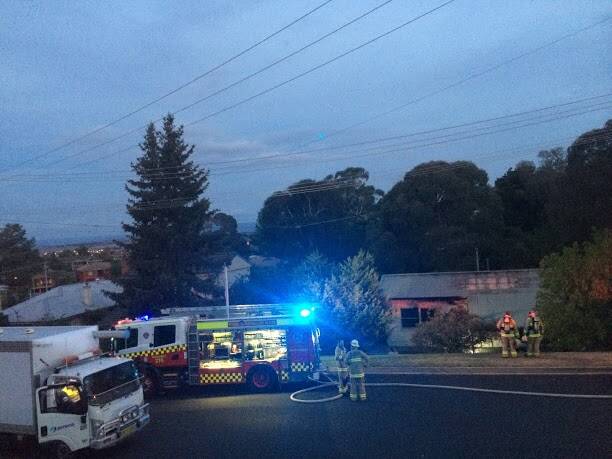 Firefighters mop up at the scene of a house fire on Esrom Street on Thursday night. Photo: Alice Coomans