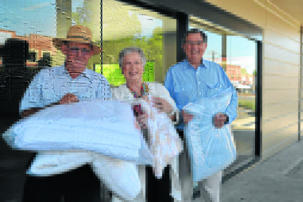 HELP WANTED: President of Bathurst Lions Club Terry Renshaw, Mayor of Bathurst Monica Morse and building owner Bruce Bolam get things ready at the collection centre for Bathurst's big whitegoods appeal. Photo: LOUISE EDDY 	011713appeal