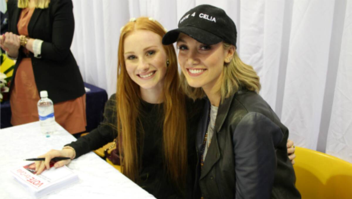 Celia Pavey and Delta Goodrem signing autographs on their visit to Forbes. Photo: Stacey Miller