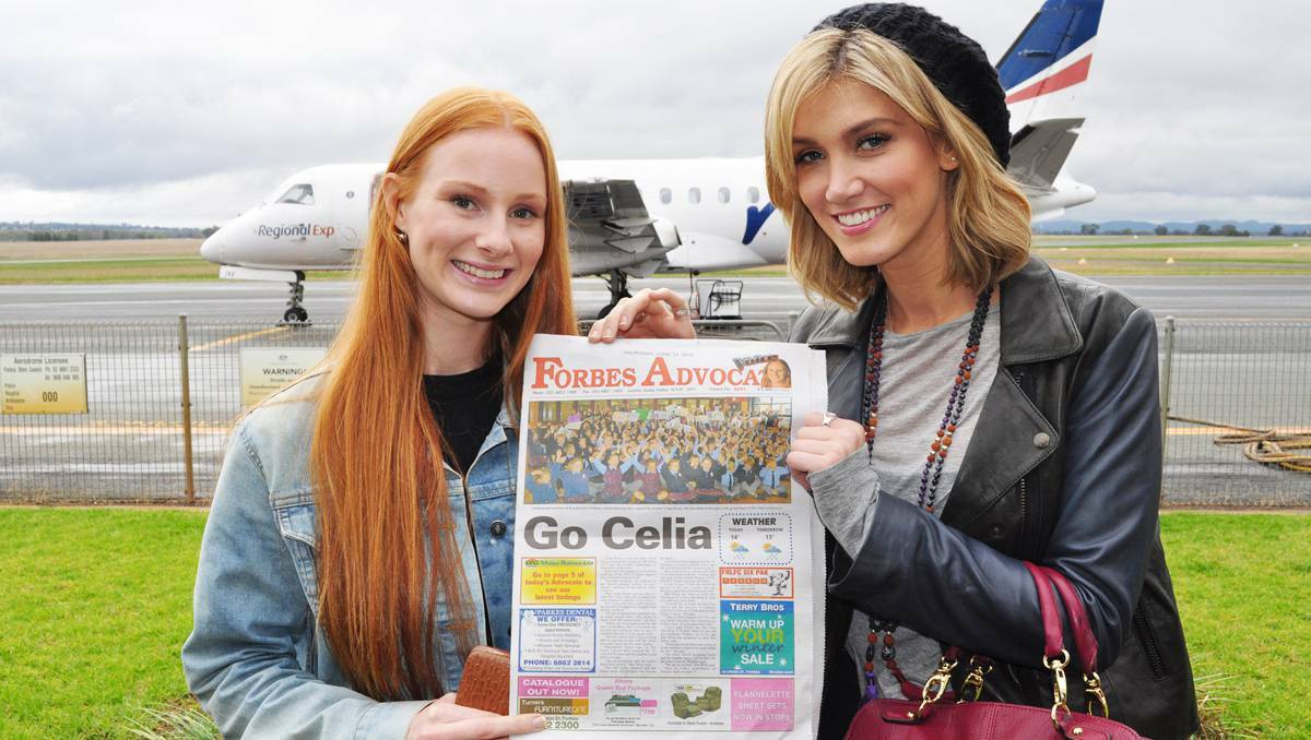 Celia Pavey and Delta Goodrem with a copy of the Forbes Advocate, which has been right behind Celia's quest to win The Voice.