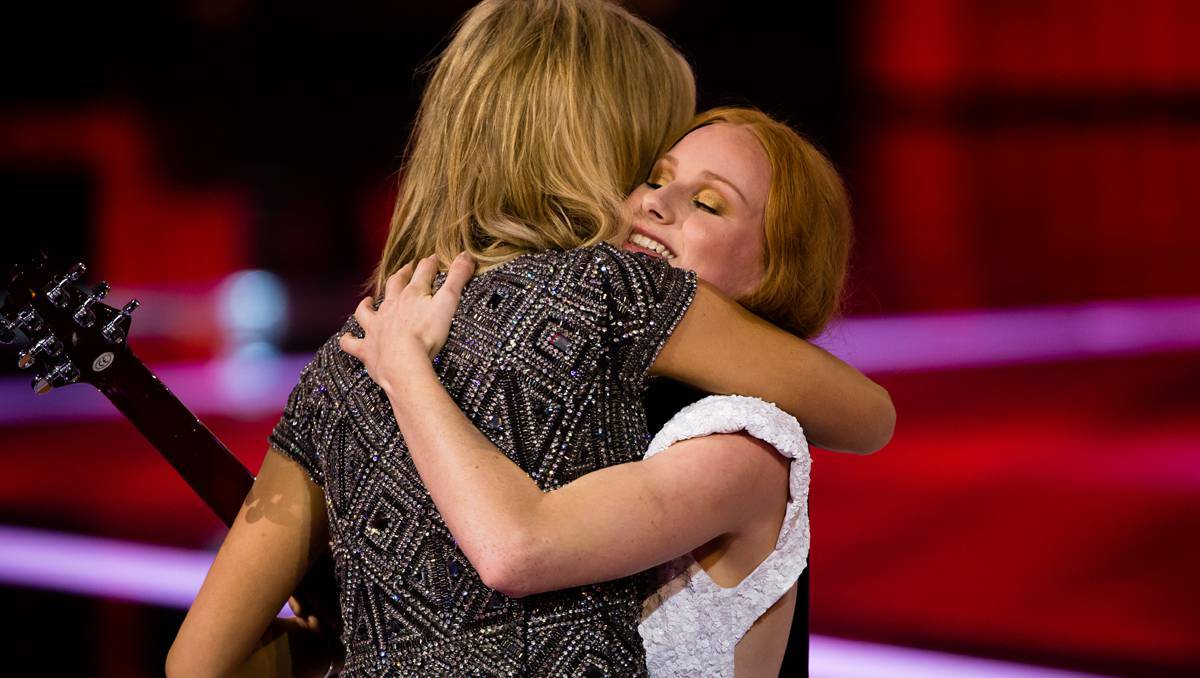 Celia Pavey embraces her coach, Delta Goodrem, after being voted through to the next round of WIN TV’s The Voice on Tuesday May 14. Photo supplied by The WIN Network.