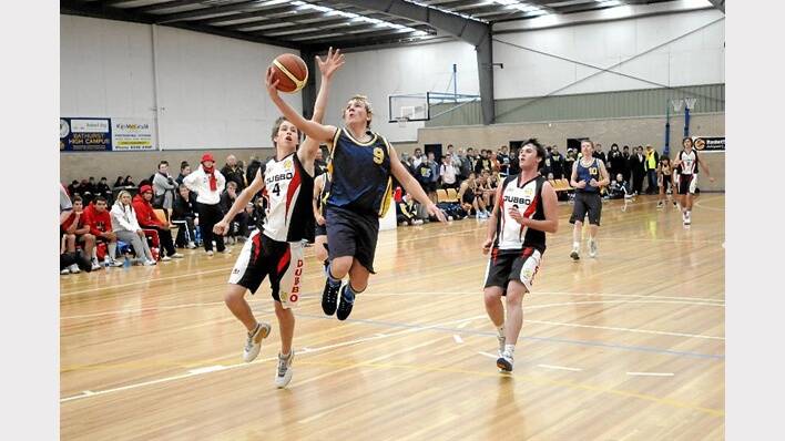 2010: Bathurst’s Jayden Taylor drives to the basket despite the attention of Dubbo’s Michael Townsend.