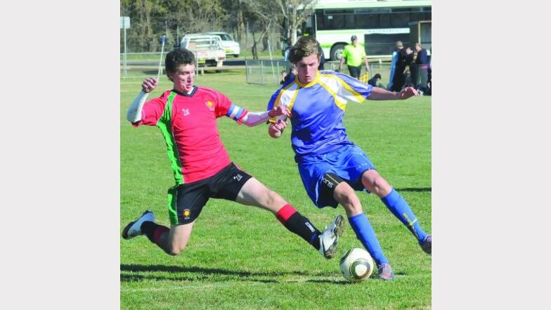 2010: Bathurst High School's Alex Miller clashes with a Dubbo opponent during an Astley Cup soccer match. Photo: CHRIS SEABROOK 063010cupsoc1